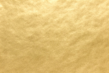Uneven surface of yellow golden craft paper texture with lines.
