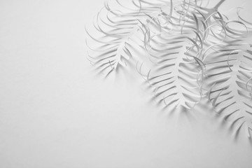 Abstract decorative background with white paper feathers on white background