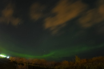 Obraz na płótnie Canvas Aurora borealis in night northern sky. Ionization of air particl