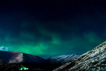 Obraz na płótnie Canvas Aurora borealis in night northern sky. Ionization of air particl