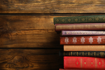 Collection of different books on wooden background. Space for text