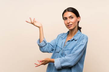 Young woman over isolated background extending hands to the side for inviting to come