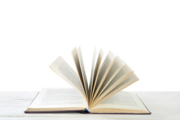 Open old hardcover book on wooden table