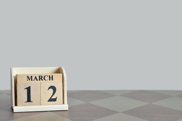 March 12, Empty Background with number cube on the table.	