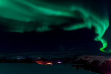Aurora borealis in night northern sky. Ionization of air particl
