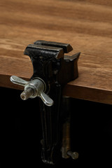 Bench vice on the desktop, the main tool for performing locksmith work.