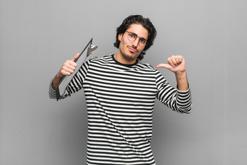 Fototapeta premium Young employee man holding an inventory feels proud and self confident, example to follow.
