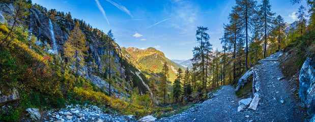 Autumn alpine waterfall view from mountain hiking path to Tappenkarsee, Kleinarl, Land Salzburg,...