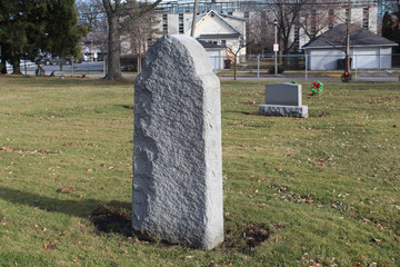 Tall gray granite gravestone at a small suburban Chicago cememtery
