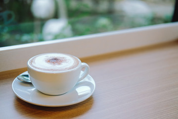 hot cappuccino latte coffee on wood table.