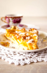 Homemade fruit apple apricot peach pie on white crochet napkin on white rustic table background