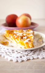 Homemade fruit apple apricot peach pie on white crochet napkin on white rustic table background