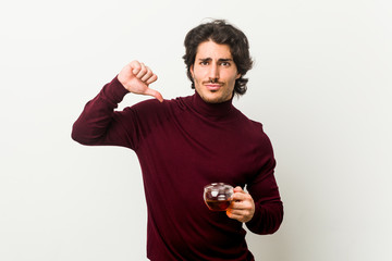 Young man holding a tea cup feels proud and self confident, example to follow.