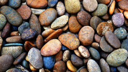 pebbles on the beach background, colorful smooth stone