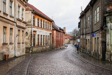 Fototapeta na wymiar Beautiful small citybrick road, path street with interesting, old architecture.