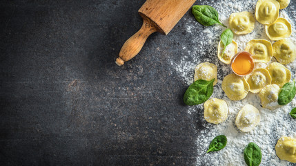 Raw ravioli with flour egg musrooms and and spinach - Top of view. Italian or mediterranean healthy cuisine