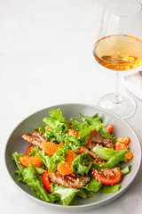 Salad with sweet tangerines and pieces of pork