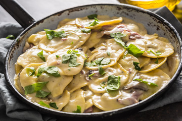 Pasta ravioli stuffed with spinach mustooms prosciutto basil and parmesan cheese