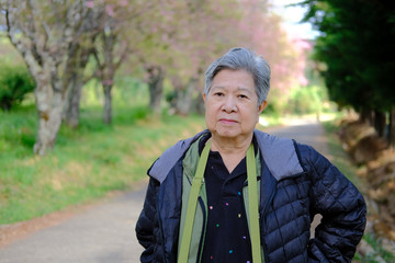 old elder woman resting in garden. elderly female relaxing outdoors. senior leisure lifestyle