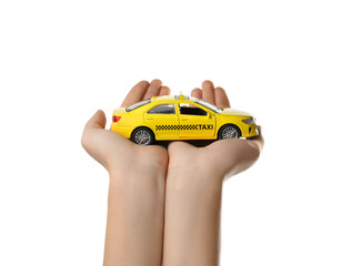 Woman with taxi car model on white background, closeup