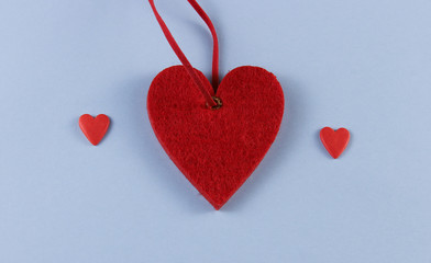big heart and two small ones on a blue background with place for text