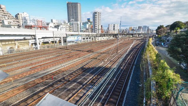 Train passing on railway in the Tokyo city and city view in the background. Tokyo's train/subway train moving in city center of Tokyo. Tokyo Olympic 2020 4K UHD video of Tokyo city's transportation