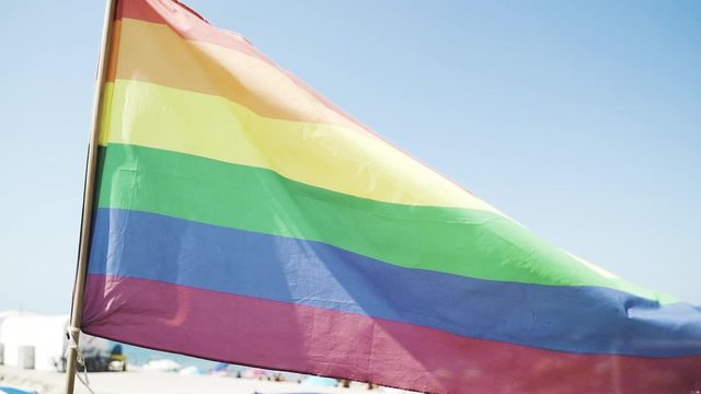 Rainbow Flag - Gay Pride Flying Briskly In Wind. Slow motion from original 120fps footage.