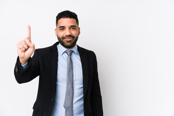 Young latin business woman against a white background isolated showing number one with finger.