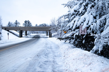 Slippery snow covered road and forest in central Wisconsin and no cars
