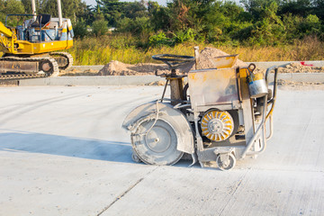 The joint cutter machine on a brushed concrete surface. Construction equipment for cutting saw slab.