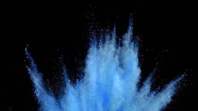 Realistic blue powder explosion on black background. Slow motion with acceleration in vertical motion