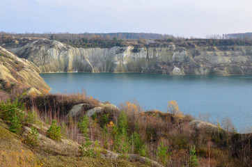 Chalk quarry artificial lakes in autumn season. Technogenic open pit is known as the Belarusian...