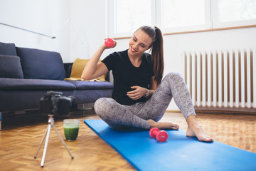 woman sports vlogger making video in her home