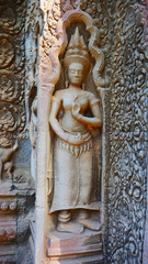 Fototapeta na wymiar Stone rock carving art at Ta Prohm Temple in Angkor wat complex, Siem Reap Cambodia.