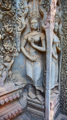Fototapeta na wymiar Stone rock carving art at Ta Prohm Temple in Angkor wat complex, Siem Reap Cambodia.