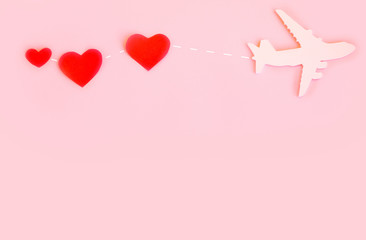 Happy Valentines day. Children's plane on a pink background with red heart