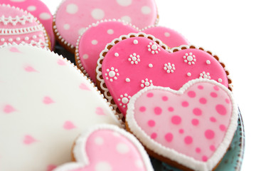 set of pink heart shaped cookies with patterns, light background