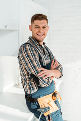 happy installer standing with crossed arms