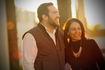 Portrait of young man couple with beard and young woman smiling and enjoying the company posing for the camera. Laughing couple.