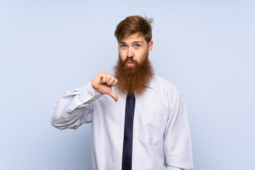 Businessman with long beard over isolated background showing thumb down sign