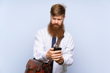 Businessman with long beard talking to mobile over isolated background