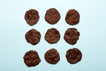 Homemade gluten-free chocolate chip cookies with cereals, nuts and organic cocoa. Cookies and pastries from rye flour on a colored background. Gluten free concept
