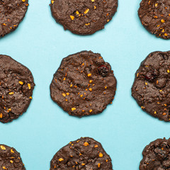 Homemade gluten-free chocolate chip cookies with cereals, nuts and organic cocoa. Cookies and pastries from rye flour on a colored background. Gluten free concept