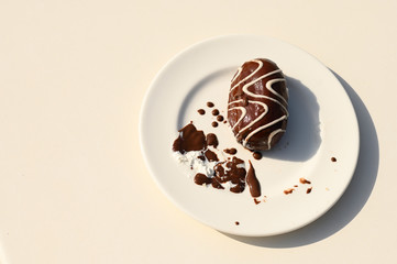 a layout with place for text on a white plate is a half-eaten chocolate cake, nutrition concept