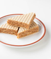 Fresh home made waffle cake with condensed milk. On a white background.