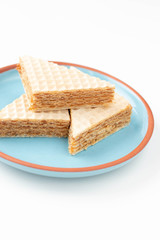 Fresh home made waffle cake with condensed milk. On a white background.