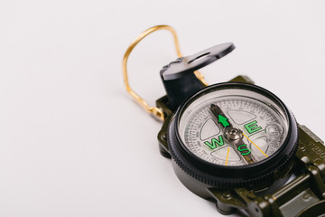 metal navigation travel compass on a light gray background. search for a way. point of view