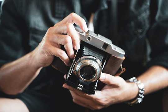 a man holding the vintage old film camera  