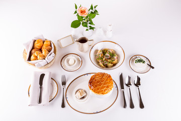 Served table with borsch and dumplings, with basket of bread and sauce