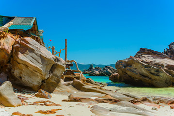 Scenic cliffs on a sandy tropical Thai beach.